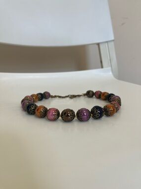 Necklace by Bulatti, featuring decorative metal caps